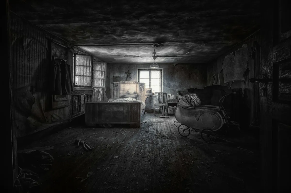 A dark derelict bedroom with a bed and a rocking chair. Illustrative stock photo, not the house in the judgment.